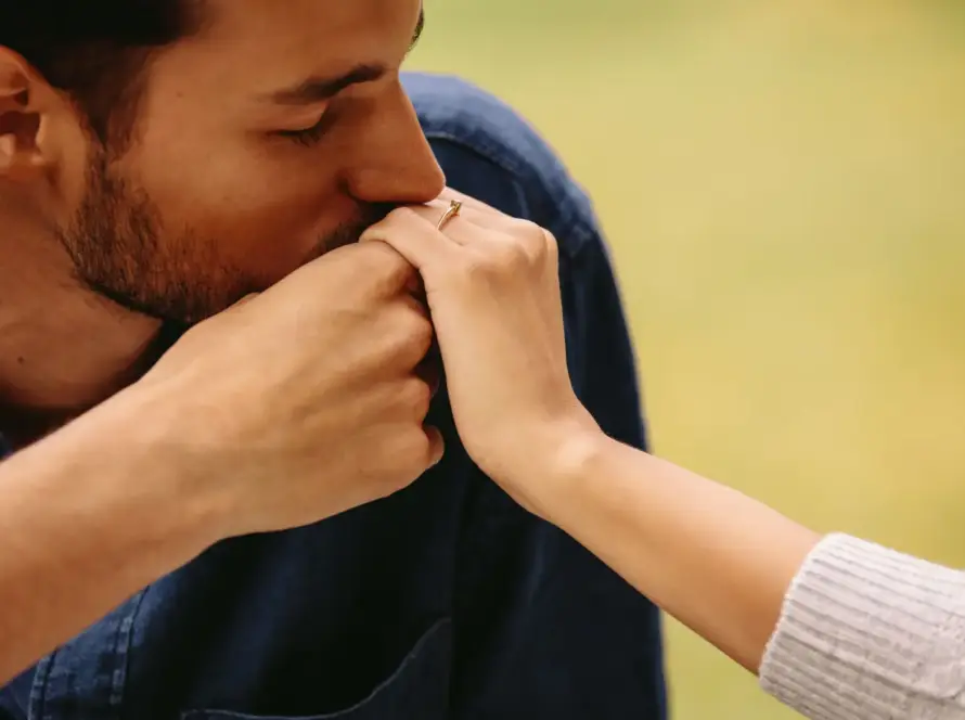 man kissing a woman's hand