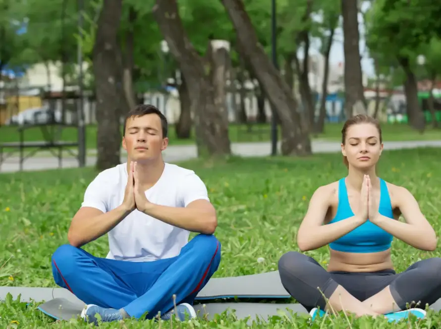 couple meditating in nature